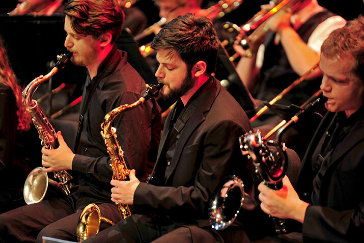 Image of the saxophone section of the jazz lab band performing during a concert.