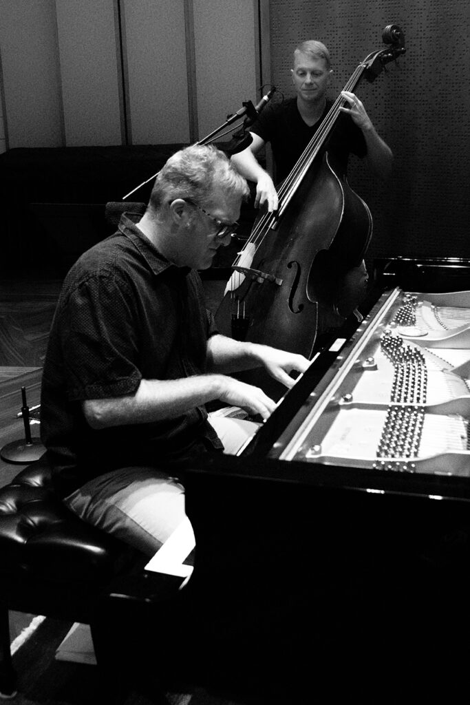 Image of pianist Stephen Anderson and applied lecturer and bassist Jason Foureman in the recording studio.