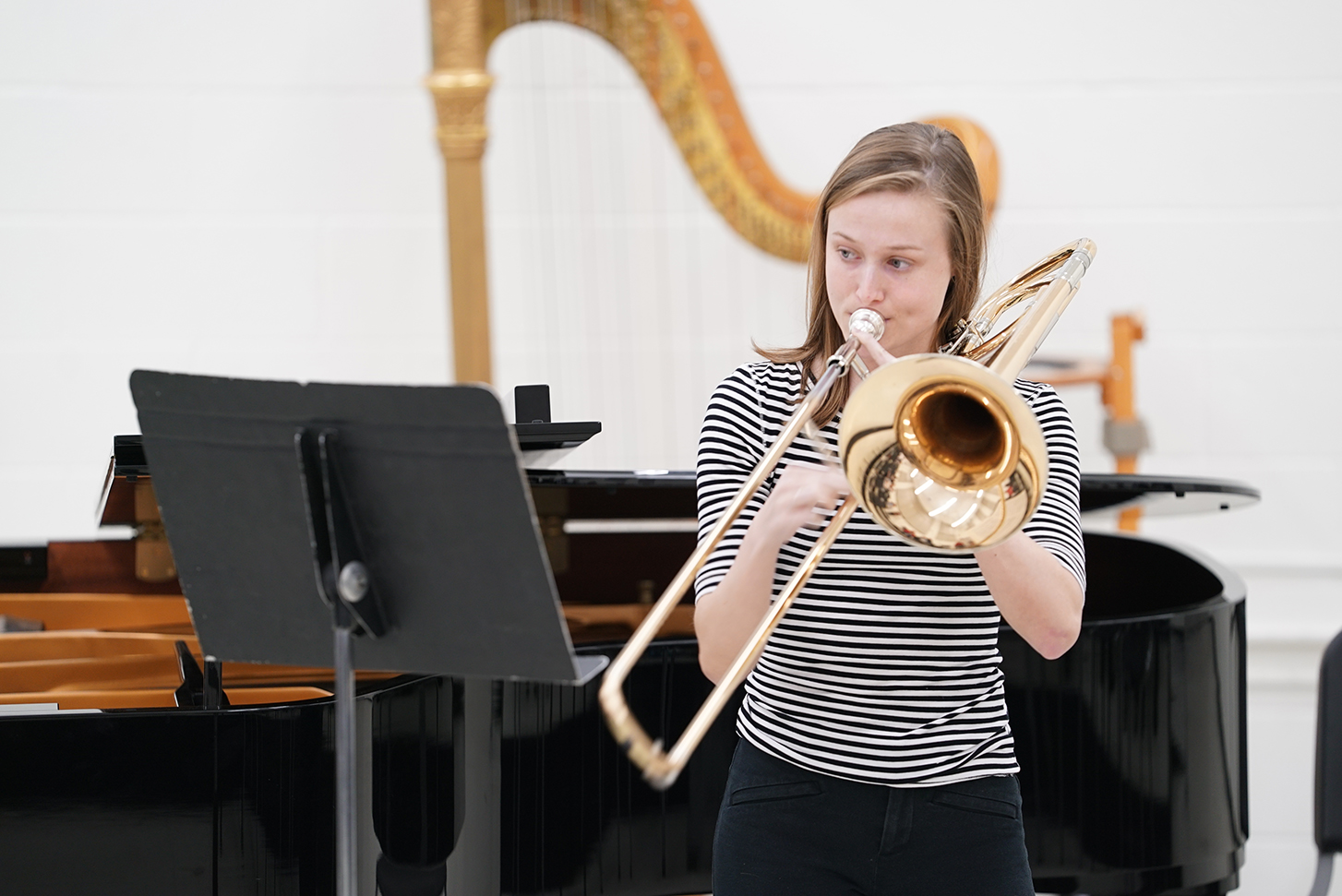 A student plays the trombone during a recital