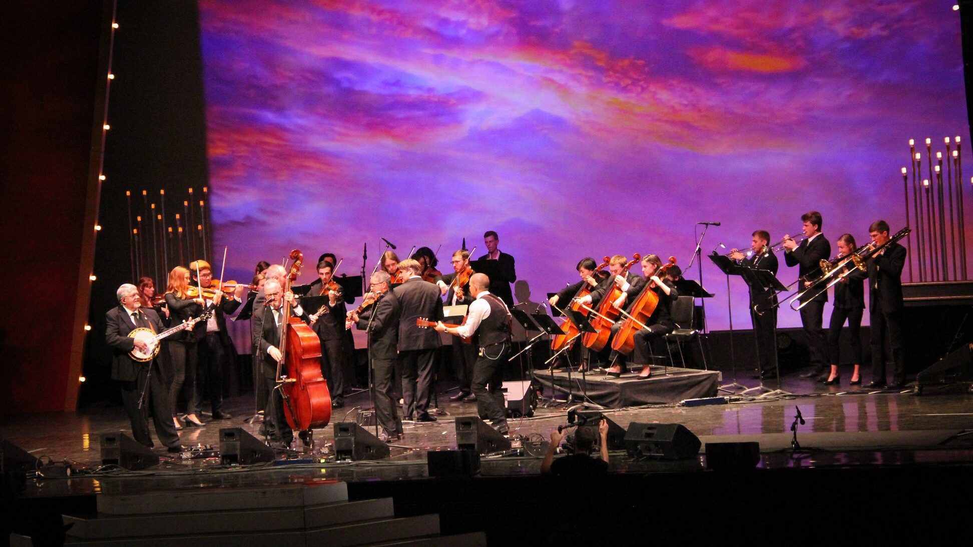 Photo of orchestra students performing on stage with Balsam Range during the International Bluegrass Music Awards.