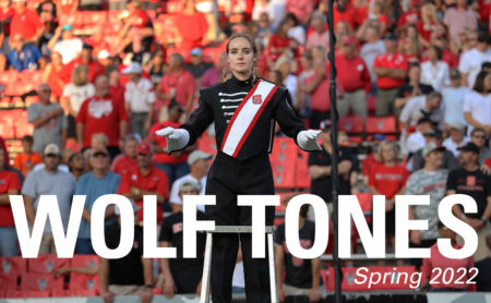 Cover of digital issue of Wolf Tones with image of drum major Laura Dugan conducting.