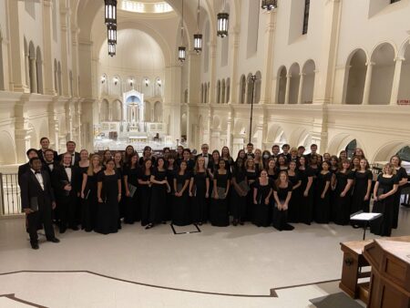 Choir students posing in a large church