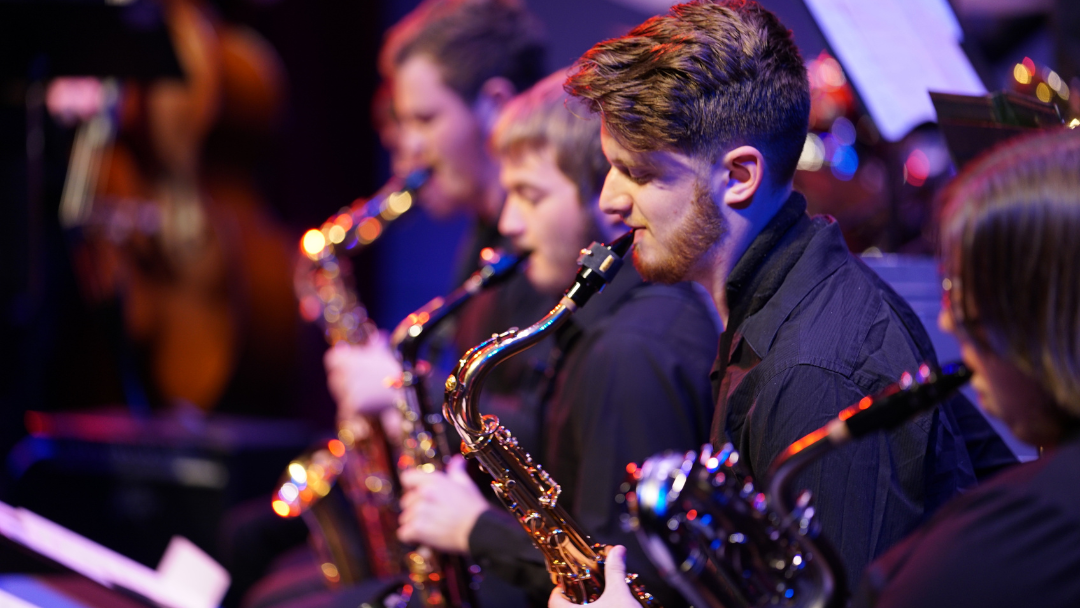 Jazz musician playing a saxophone in a concert