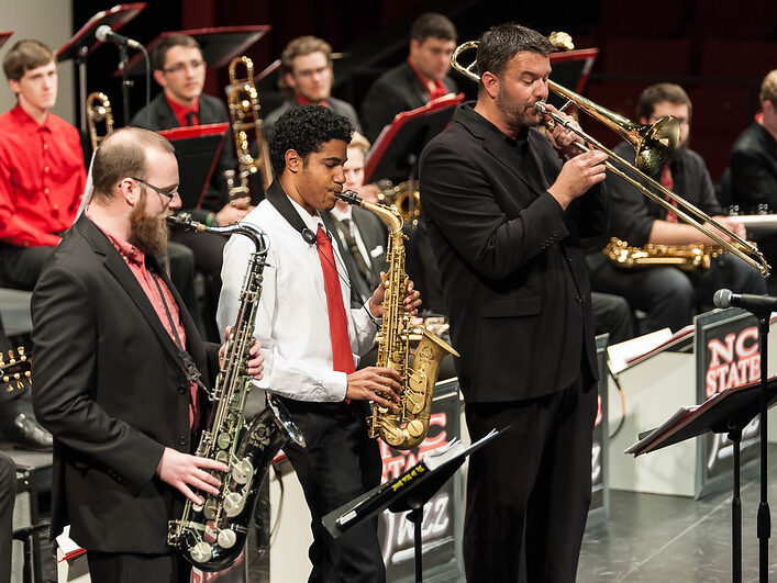 A faculty member performs in a jazz concert with his students.