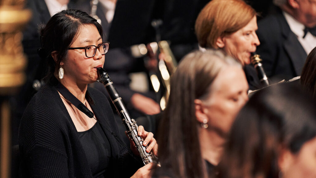 oboist performs with an orchestra in a concert.