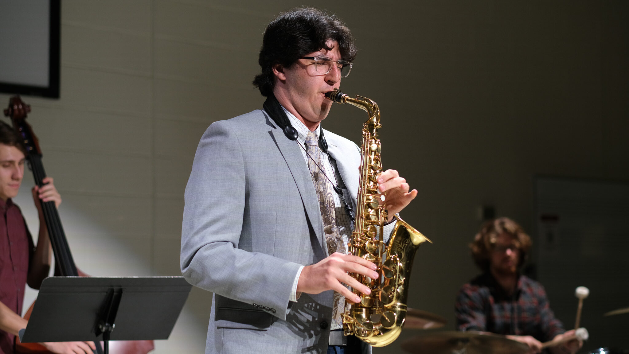 Saxophonist performing in a recital.